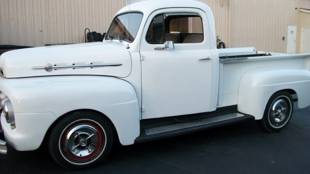 White vintage Ford pickup truck.