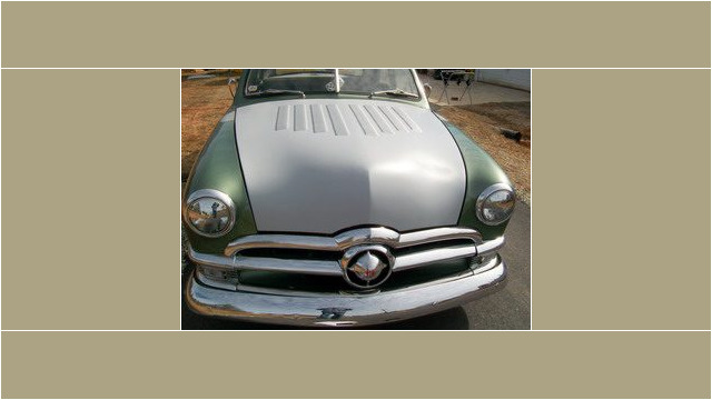 Here's an alt tag for the image: Vintage Ford car, custom hood.