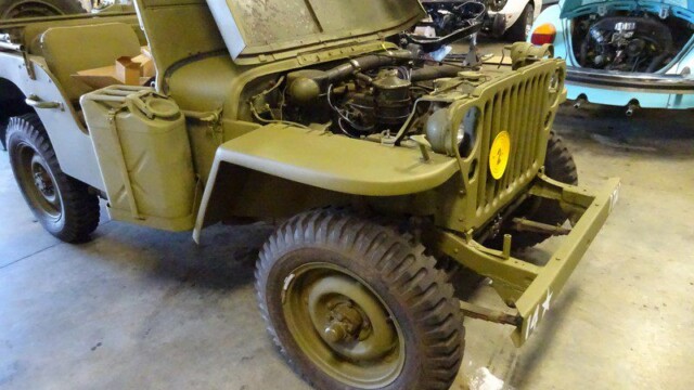 Military Jeep, olive green, open hood.