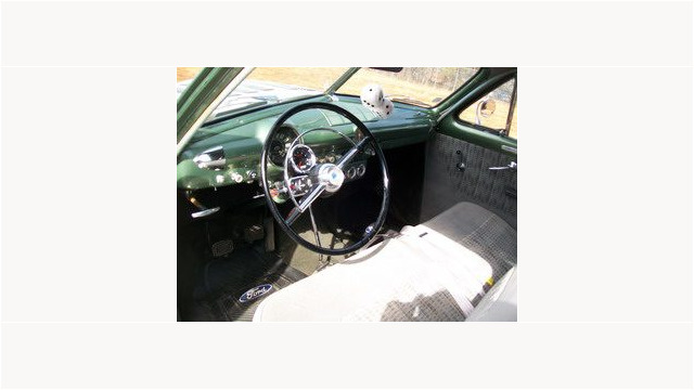 Here's an alt tag for the image: `1949 Ford interior, green dashboard`