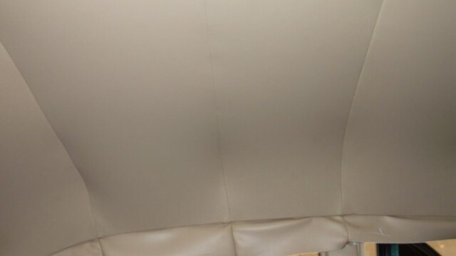 Beige car headliner interior detail.