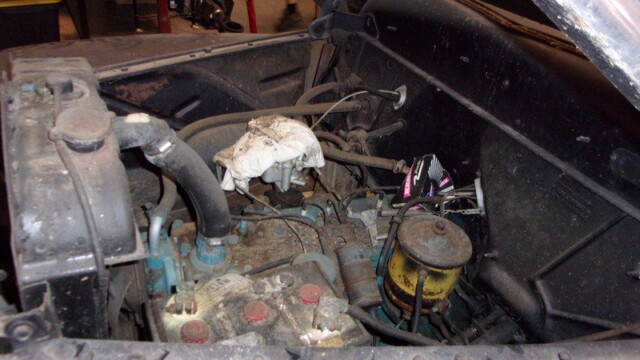 Dirty classic car engine bay.