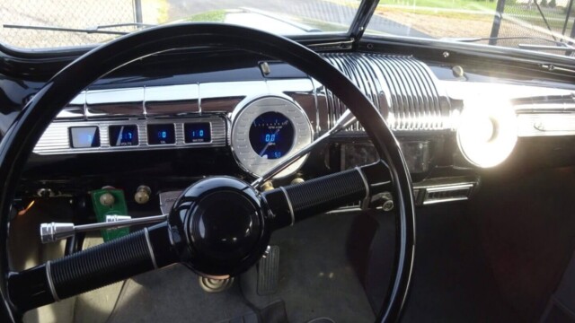 Here's an alt tag for the image: Vintage car's interior dashboard.