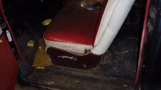 Dirty classic car interior, red seat.