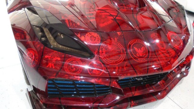 Red Corvette with military seals wrap.
