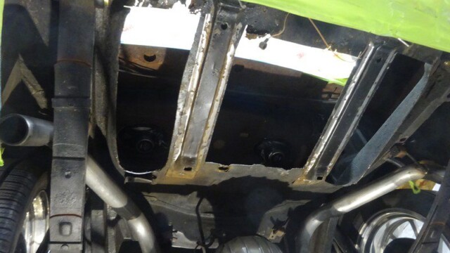 Car undercarriage repair in progress.