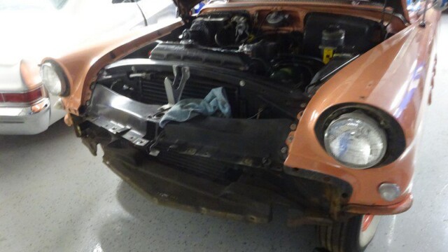 Damaged vintage car under repair.