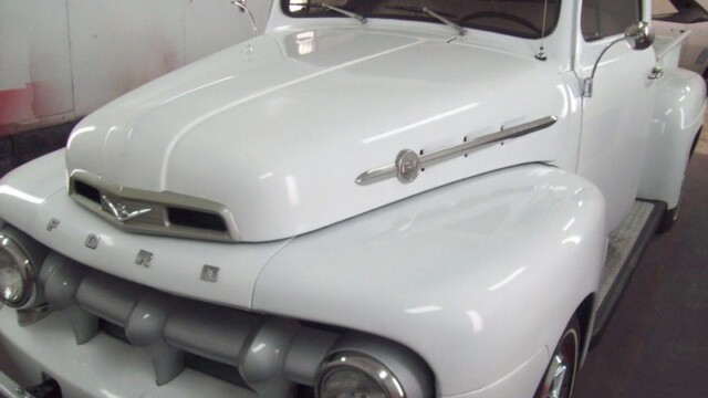 White vintage Ford pickup truck.