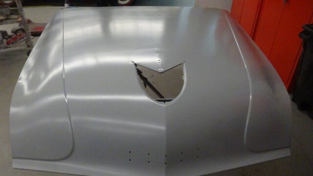Silver car hood, primed and ready.