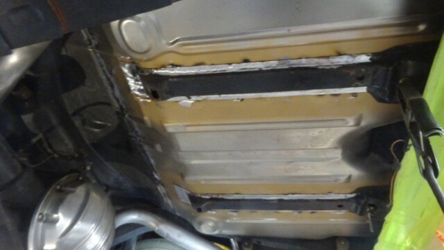 Underside car body repair welding.