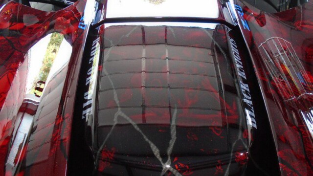 Red custom car engine cover detail.