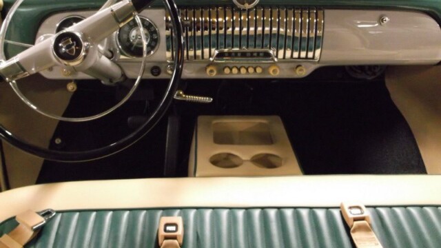 Classic car interior, teal and beige.