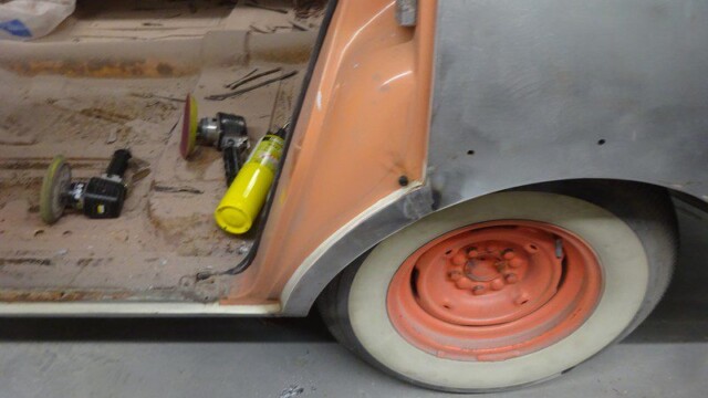 Whitewall wheel and sanding tools on floor