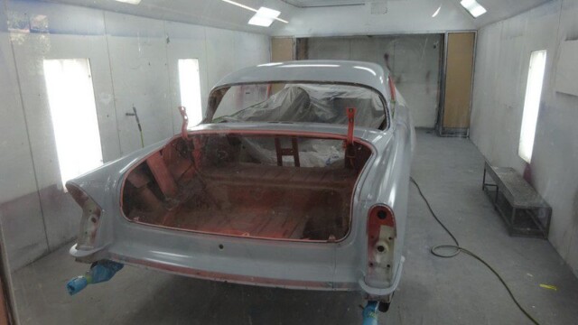 Stripped 1950s sedan undergoing priming