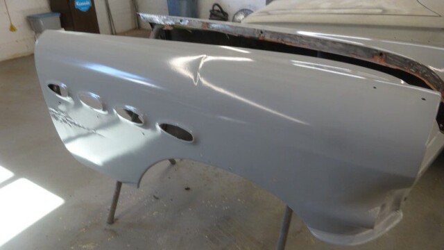 Gray car body panel, primered.