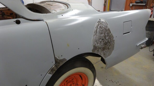 Grey classic car body repair in progress.