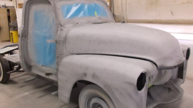 Primered vintage Chevrolet pickup truck.