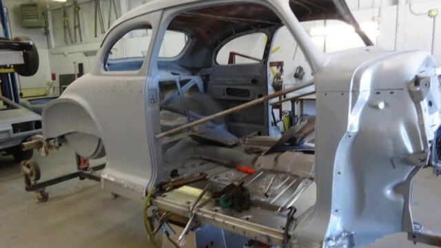 Classic car body undergoing restoration.