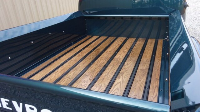 Vintage Chevrolet truck bed with wood planks.