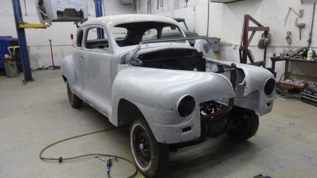 Classic car body in restoration shop.