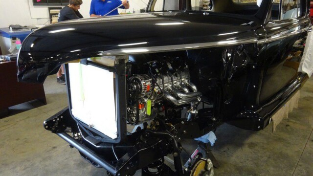 Black classic car under restoration.