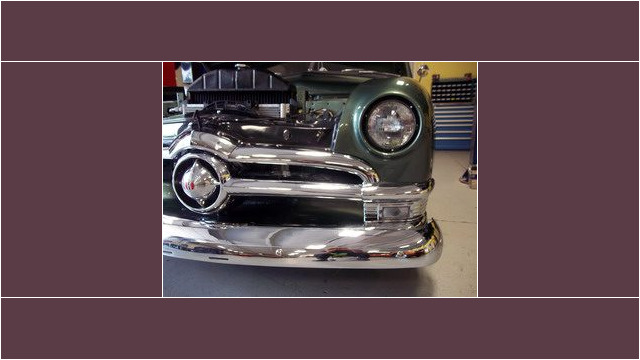 Here's an alt tag for the image: `1950 Ford car front bumper close-up`