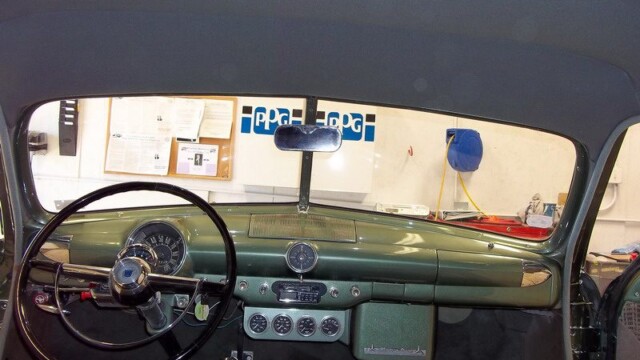 Green classic car interior dashboard.