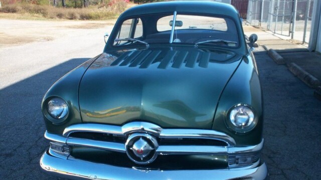Restored vintage Ford car front view.