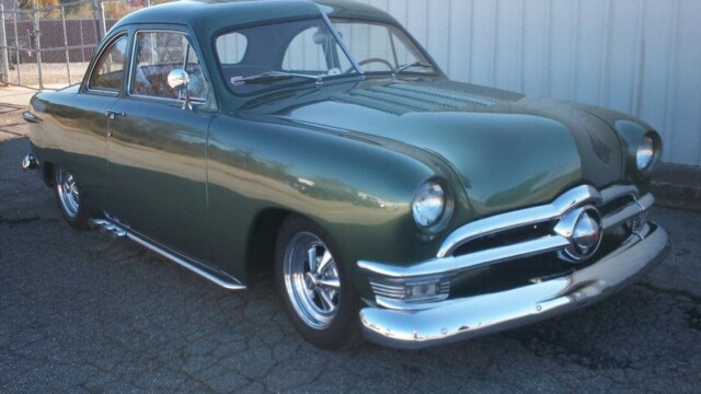 Custom 1949 Ford coupe, dark green.