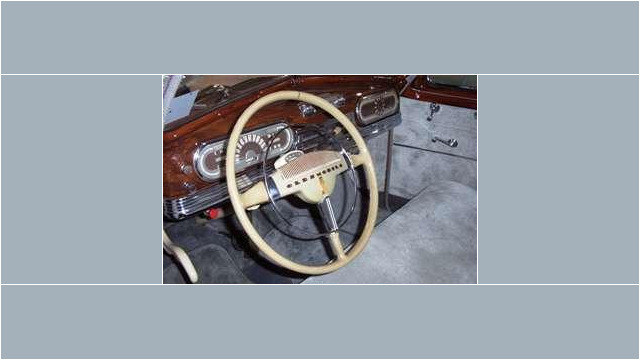 Here's an alt tag for the image: `Vintage Oldsmobile car interior dashboard`