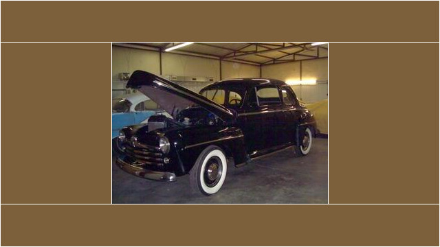 Here's an alt tag for the image: Black 1947 Ford Coupe, hood up.