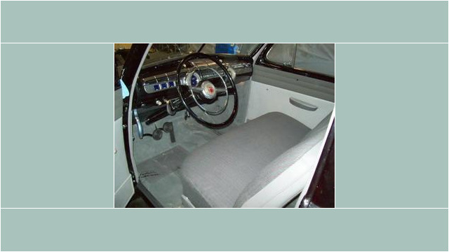Here's an alt tag for the image: `1940s Ford car interior`