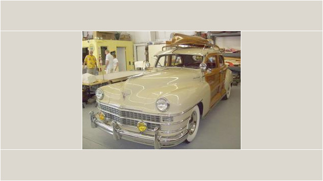 Here's an alt tag for the image: Cream-colored vintage Chrysler Town & Country station wagon.
