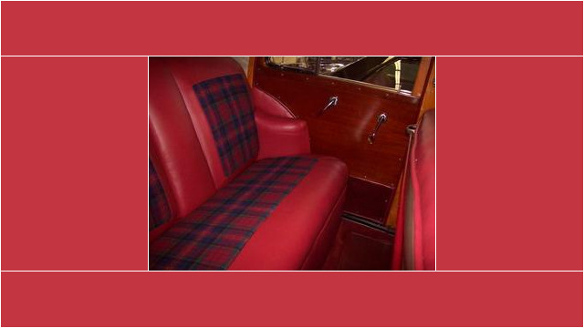 Here's an alt tag for the image: Red leather and plaid car interior.