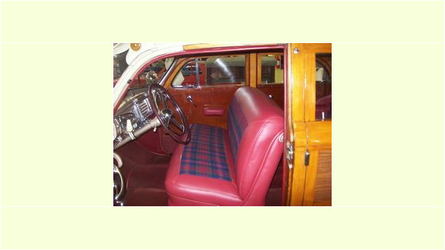 Here's an alt tag for the image: Vintage wooden station wagon interior.