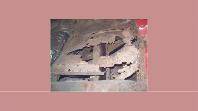 Severely rusted car floor panel.