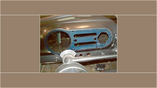 Here's an alt tag for the image: `Classic car dashboard, under restoration.`