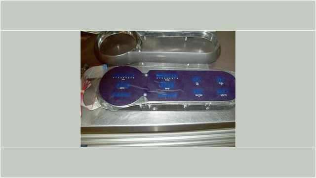 Here's an alt tag for the image: Purple automotive gauge cluster, new.