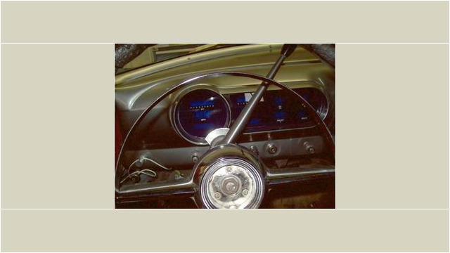 Here's an alt tag for the image: Custom car dashboard with blue gauges.