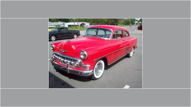 Here's an alt tag for the image: Red 1951 Chevrolet classic car.