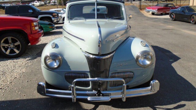 Vintage light blue Ford convertible car.