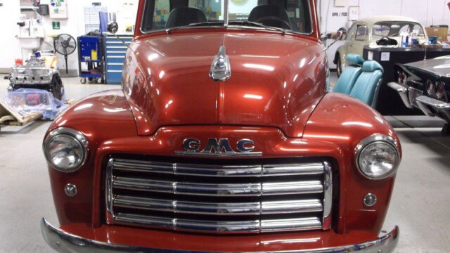 Red GMC vintage truck front view.