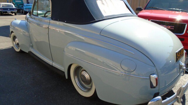 Light blue 1940s Ford convertible.