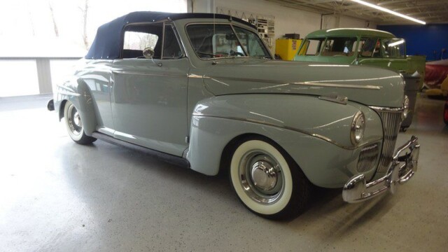 Light blue 1940s Ford convertible.