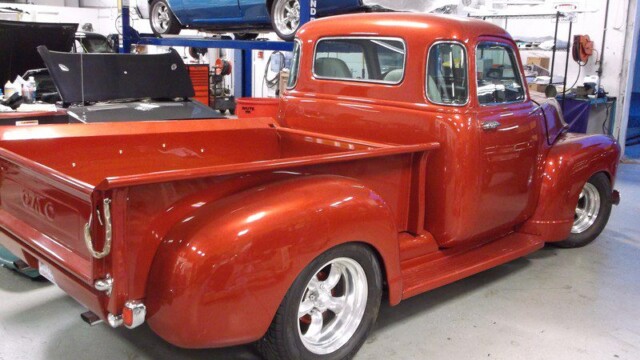 Custom orange GMC pickup truck.