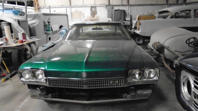 Green color car on the display of the website