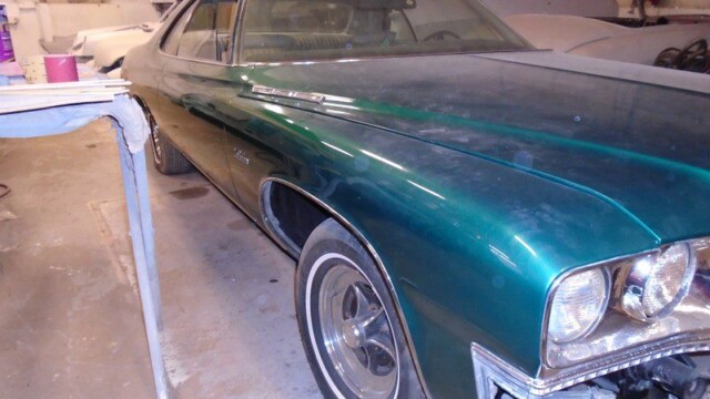 Green Buick GS undergoing restoration.