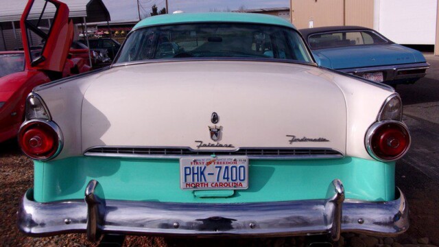 Here's an 8-word alt tag for the image: Rear view of a turquoise and white Ford Fairlane.