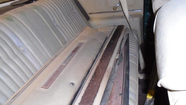 Classic car's backseat and rear panel.