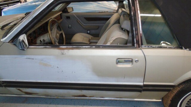 Silver Ford Mustang undergoing restoration.